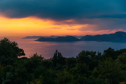 Scenic view of the bright colourful twilight overlooking the Mediterranean sea with the hills and the islands in Mugla province, Turkey