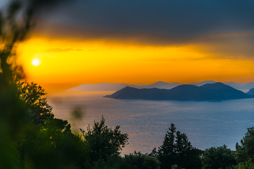 Scenic view of the bright colourful twilight overlooking the Mediterranean sea with the hills and the islands in Mugla province, Turkey