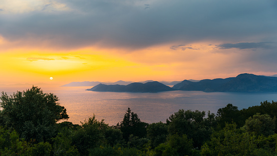 Scenic view of the bright colourful twilight overlooking the Mediterranean sea with the hills and the islands in Mugla province, Turkey