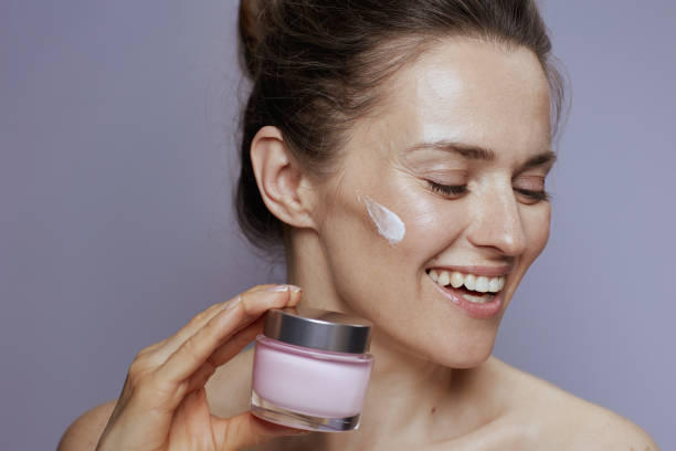 istock happy woman with cosmetic cream jar 2133084880