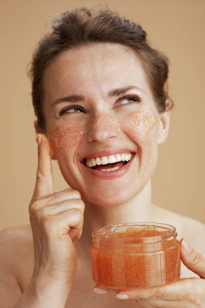 istock happy woman with face scrub 2133084884