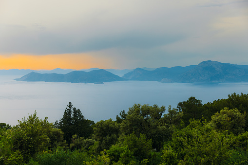 Scenic view of the bright colourful twilight overlooking the Mediterranean sea with the hills and the islands in Mugla province, Turkey
