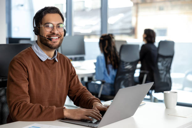 istock Smiling businessman call center agent wearing headset at workplace 2133104842