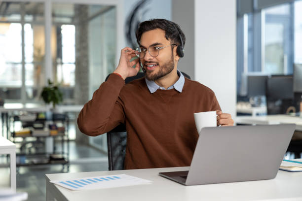 istock Smiling businessman call center agent wearing headset at workplace 2133104845