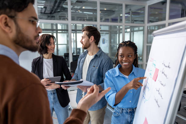 istock Group of employees training in boardroom with whiteboard and project information 2133105404