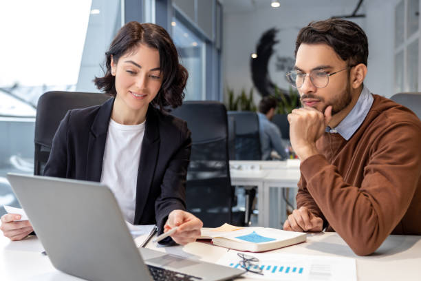 istock Executive colleagues using laptop for creating new business project sitting in office 2133105931