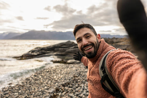 istock Smiling Man Taking a Selfie by the Lakeside 2133105950