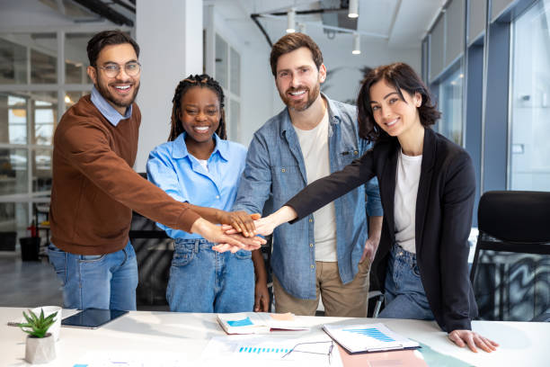 istock Happy diverse business people putting hands together 2133108182