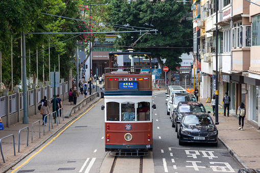 Hong Kong - March 27, 2024 : 1920s-style tour tram in Happy Valley, Hong Kong. The open-top tram will take passengers on sightseeing trips through the neighbourhoods of Central, Admiralty, Wan Chai, and Happy Valley.