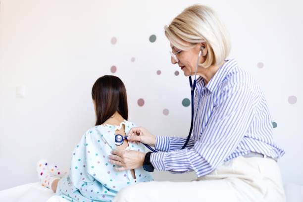 istock Doctor listening to patient’s back with a stethoscope 2133122353