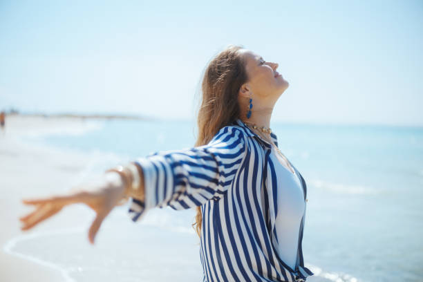 istock relaxed modern woman on ocean coast rejoicing 2133127615