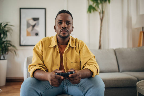 istock Relaxed man enjoying video games at home 2133176262