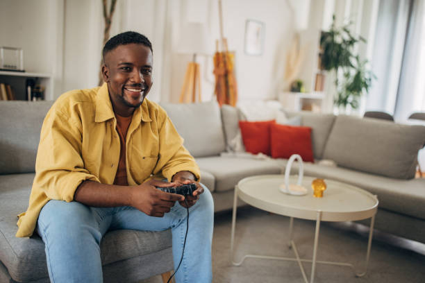 istock Relaxed man playing video games at home 2133177296