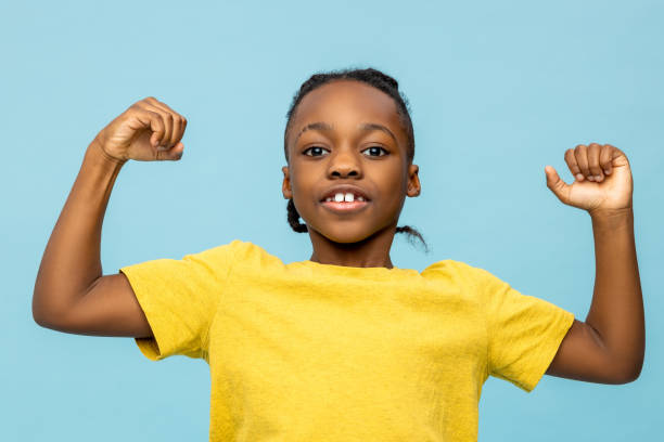 istock Dark-skinned boy in yellow tshirt with his hands up 2133191903