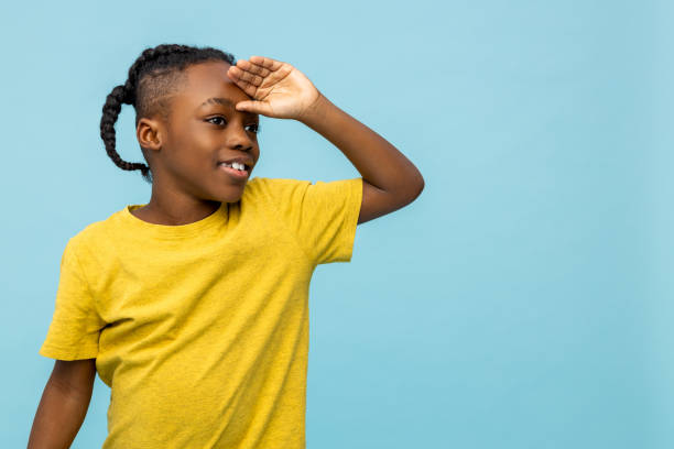 istock Dark-skinned boy in yellow tshirt waiting for someone 2133191907