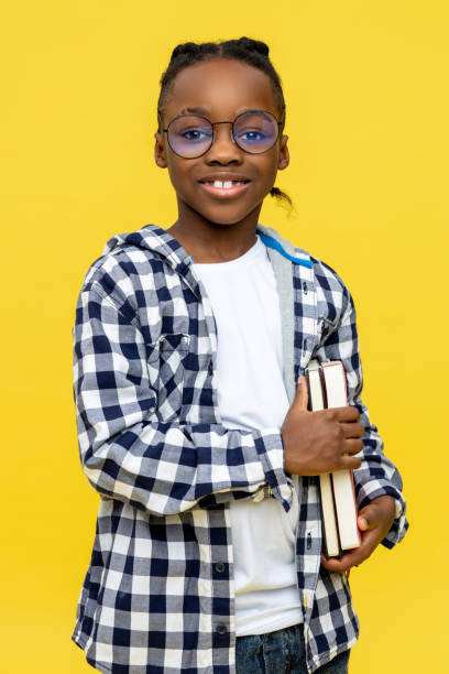 istock Cute dark-skinned boy with books in hands feeling positive 2133191920