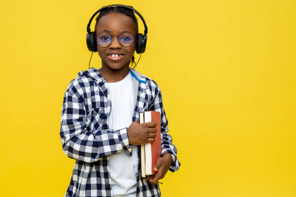 istock Cute dark-skinned boy with books in hands feeling positive 2133191921