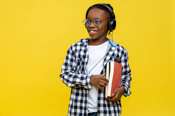 istock Cute dark-skinned boy with books in hands feeling positive 2133191925