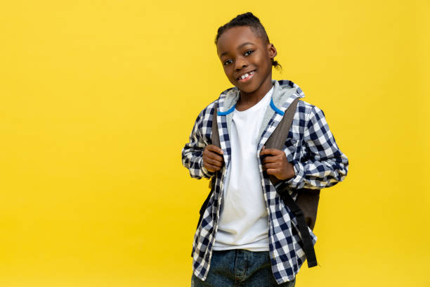 istock Cute african american schoolboy in checkered tshirt looking happy 2133191937