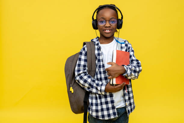 istock African american boy with backpack and book in hands 2133192458