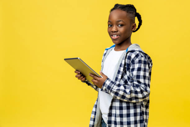 istock Dark-skinned boy of a school age with tablet in hands 2133192478
