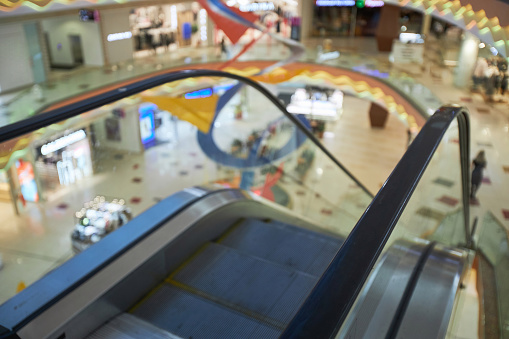 Escalators in modern shopping mall.