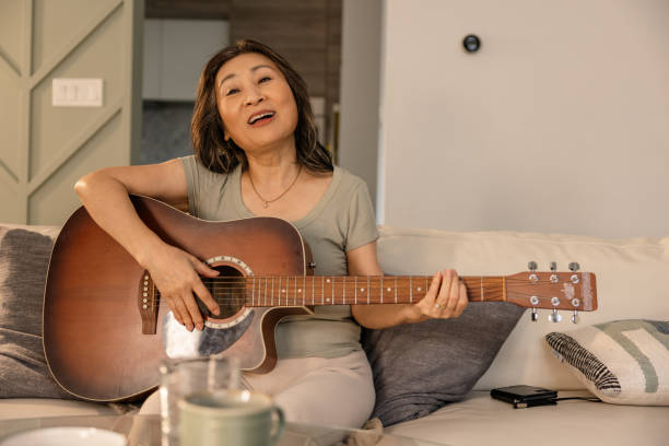 istock Elderly Encore: Senior Take the Stage with Guitar and Vocals 2133230603