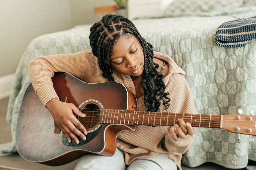 Homegrown Harmonies: Teen's Guitar Mastery Strikes a Chord in Family Life