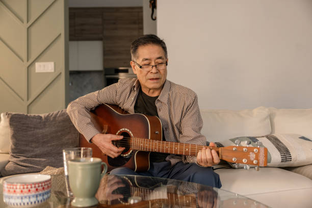 istock Elderly Encore: Senior Take the Stage with Guitar and Vocals 2133230613