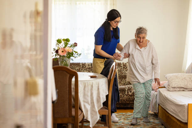istock Caregiver helping senior woman 2133230617