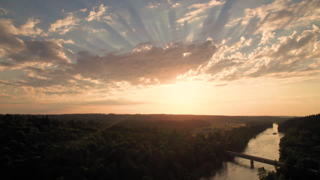 Drone Capturing Abstract Cloud Formations Over Rural River Bridge
