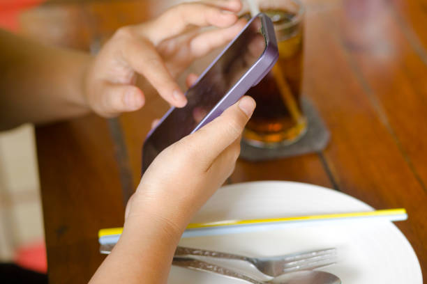 Close-up of thai woman using mobile phone
