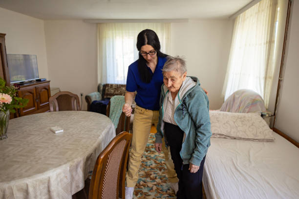 istock Young nurse helping a senior woman get dressed 2133248765