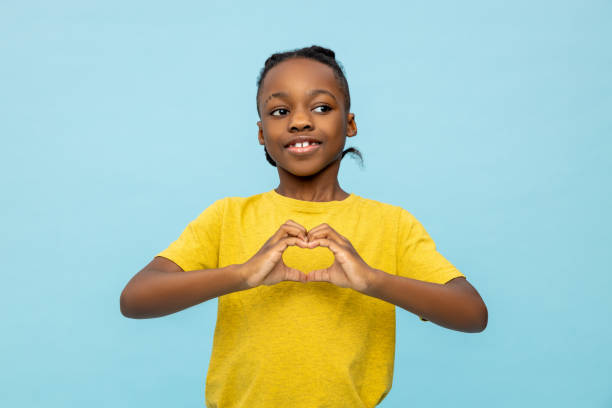 istock Satisfied dark- skinned little boy making heart with hands 2133250307