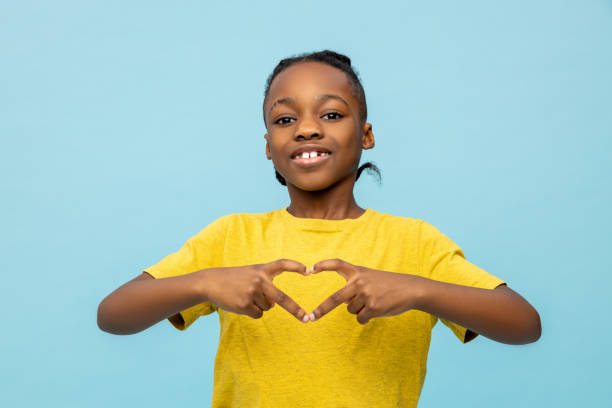 istock Smiling African American little boy making heart shape gesture 2133250313