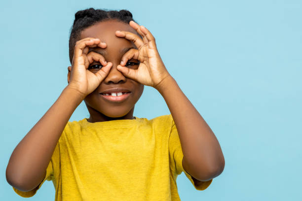 istock Joyful African American little boy making binoculars with hands 2133250888