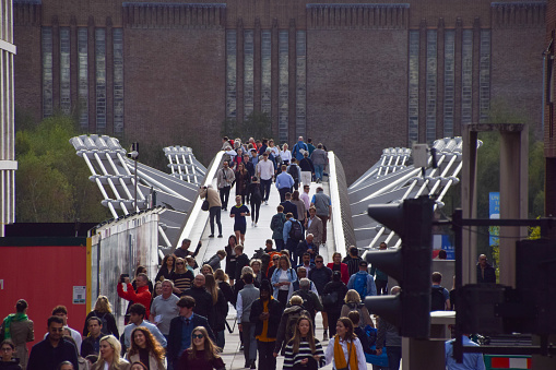 London, UK - October 5 2023: People walk across Millennium Bridge