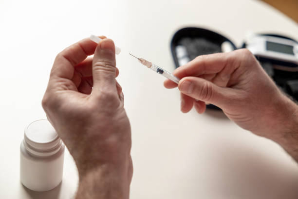 istock Unknown diabetic man with syringe preparing for insulin injection 2133323897
