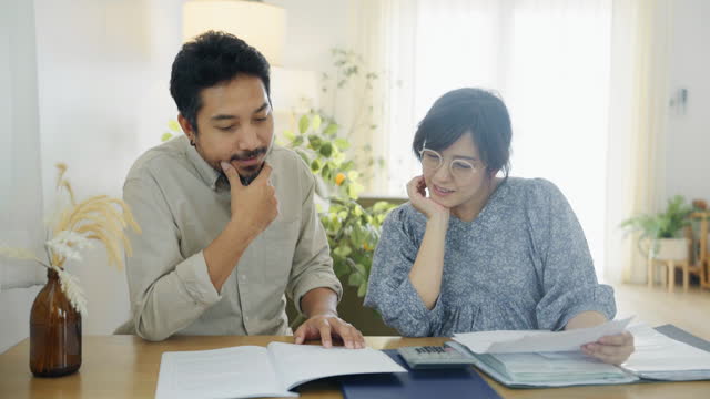 Asian couple discussing and planning insurance and home economy