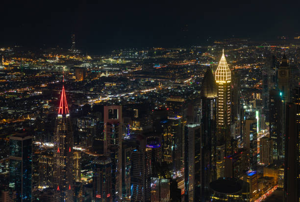 A picture of the tall buildings at the Trade Centre district at night.