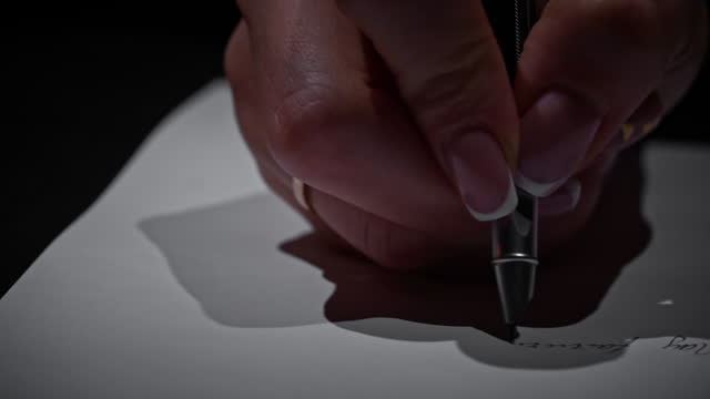 Man's Hand Writes with an Antique Pen on White Paper Close-up