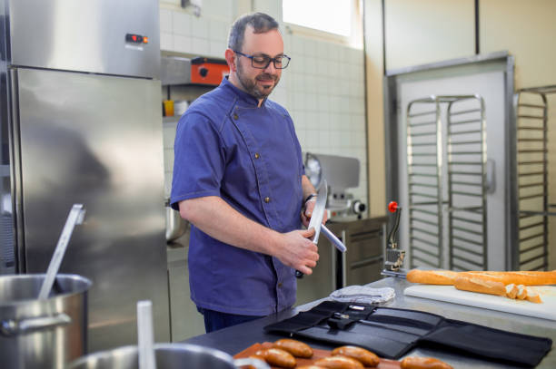 istock Man in eyeglasses working in the kitchen and looking involved 2133350957