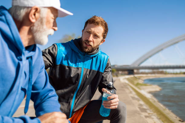 istock Father and Son Pausing During Jogging Journey 2133372538