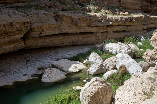 Wadi Shab, Oman, March 17, 2024: View of the canyon of the river Wadi Ash Shab on a sunny day.