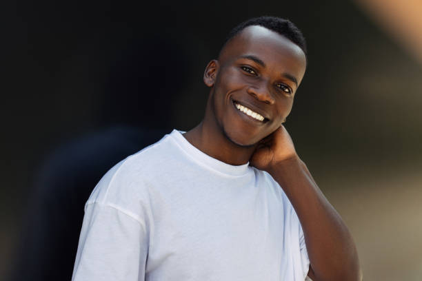 istock A cheerful and young guy smiles against a black background. 2133386989