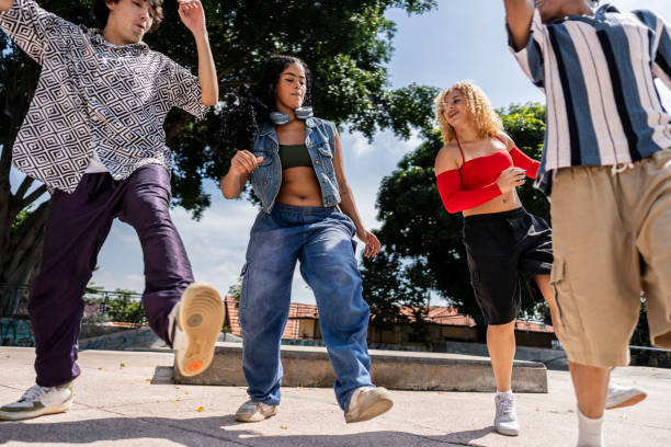 Young friends dancing outdoors