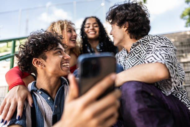 istock Young friends using mobile phone outdoors 2133395925