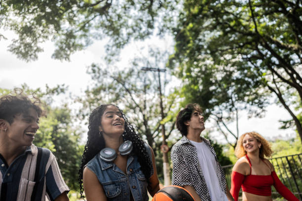 istock Young friends talking while walk at city street 2133396439