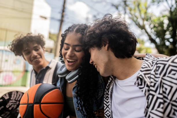 istock Young friends talking while walk at city street 2133396450