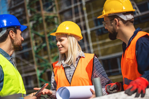 istock Construction team planning a building blueprint project on site with collaboration for architect innovation. 2133421206